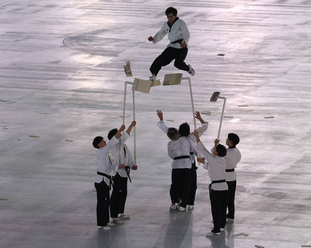 PYEONGCHANG, SOUTH KOREA - FEBRUARY 9, 2018: North-South taekwondo team performs before the opening ceremony during the Pyeongchang 2018 Olympic Winter Games at Pyeongchang Olympic Stadium - Φωτογραφία, εικόνα