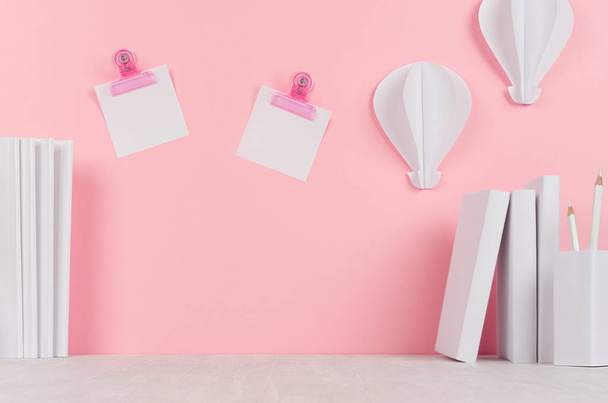 Creative workplace for designers and students - white office supples, blank stickers and paper hot air ballons origami on table and pink background. Back to school background with copy space. - Zdjęcie, obraz