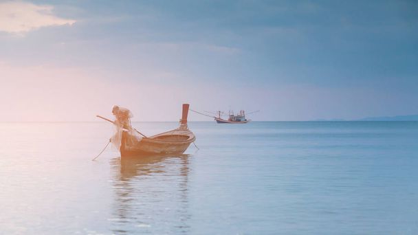 Small fishing boat over seacoast skyline, natural landscape background - Foto, Imagem