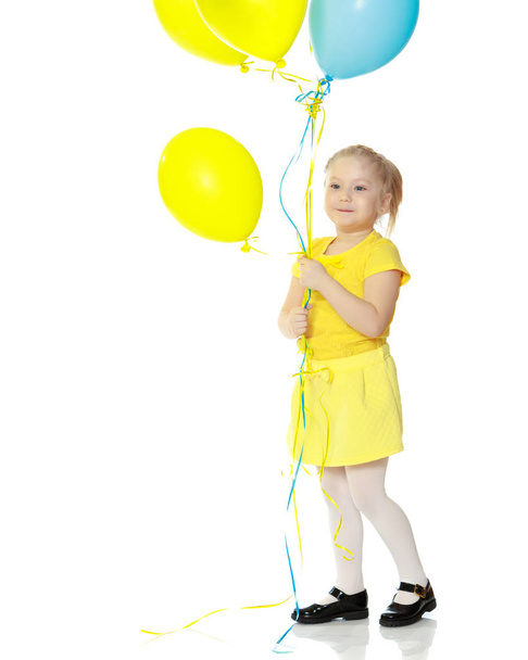 Little girl with balloons. - Фото, изображение
