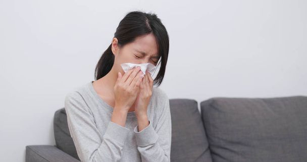 Woman sneezing and cough at home - Fotó, kép