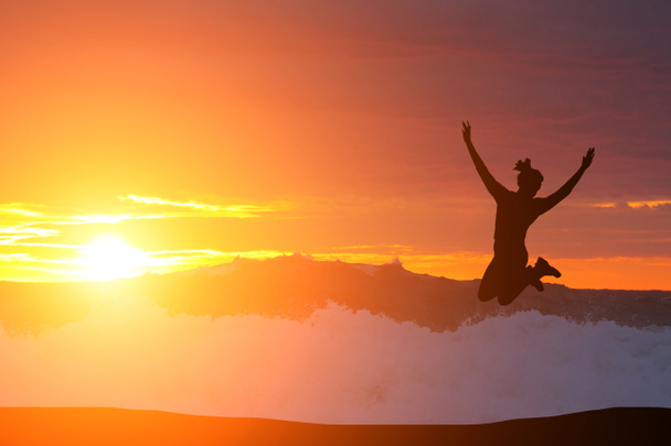 kaunis siluetti tyttö hyppäämällä auringonlaskun aikaan
 - Valokuva, kuva