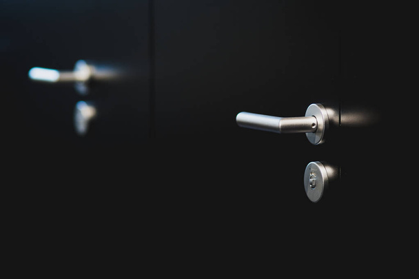 Iron door handle. Black doors and its element. Lock for key. Entrance. Safety for house. Entrance door. Close up shot. Welcome there! - Foto, imagen