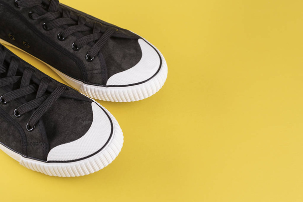 new black men's sneakers. stylish men's shoes on a yellow background, space for tex - 写真・画像
