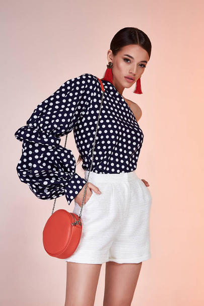 Pretty beautiful sexy elegance woman skin tan body fashion model glamor pose wear dress  short blouse dots casual clothes party summer collection makeup brunette success accessory bag jewelry studio. - 写真・画像
