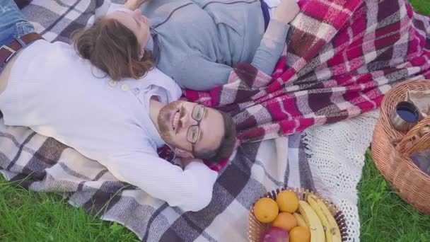 parents lying on the grass - Children have fun and running background in park - Video