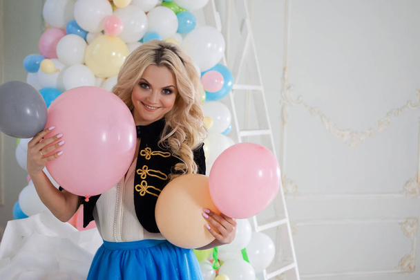 Beautiful young blonde with balloons. Colorful balls. - 写真・画像