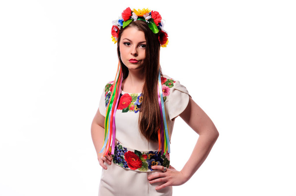 Girl in Ukrainian national traditional costume holding her flower chaplet - Photo, image