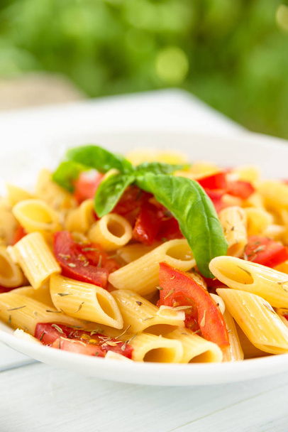 Dish of penne pasta with fresh tomatoes, olive oil, thyme and basil, Mediterranean Food  - Photo, Image