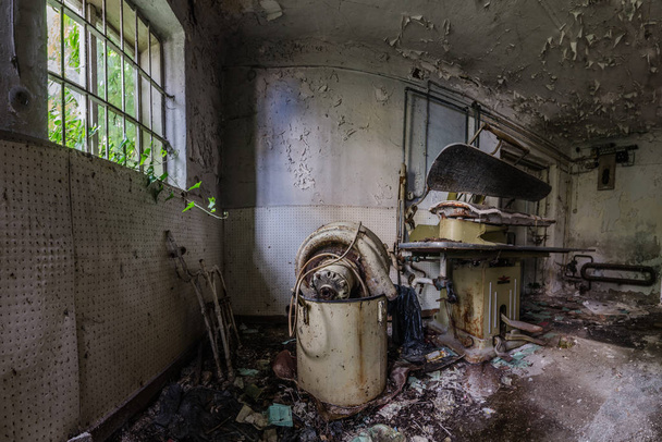 Ironing station in abandoned laundry room - Fotó, kép