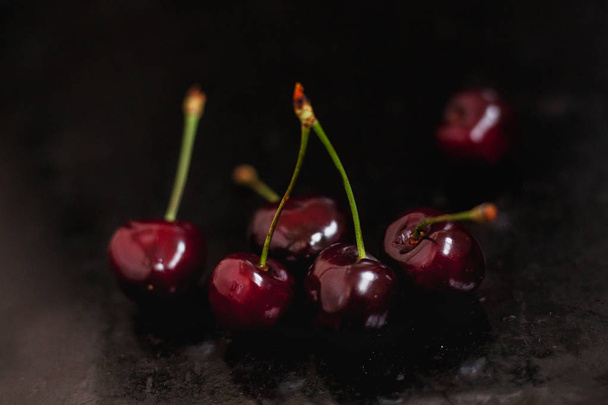 ripe cherry on a black background - Valokuva, kuva