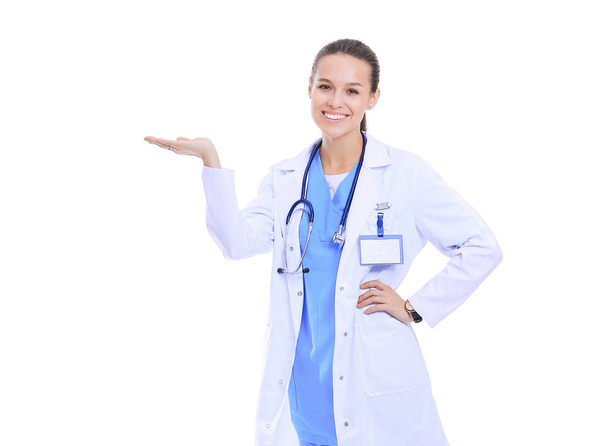 Beautiful young woman in white coat posing with hand in pocket. Woman doctor - Foto, afbeelding