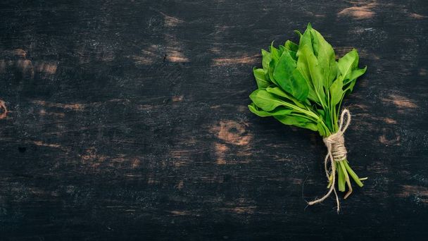 Green Fresh Spinach. On a wooden background. Healthy food. Top view. Copy space. - Foto, imagen
