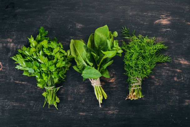 Spinach, Parsley and Dill. On a wooden background. Top view. Copy space. - Foto, Imagem