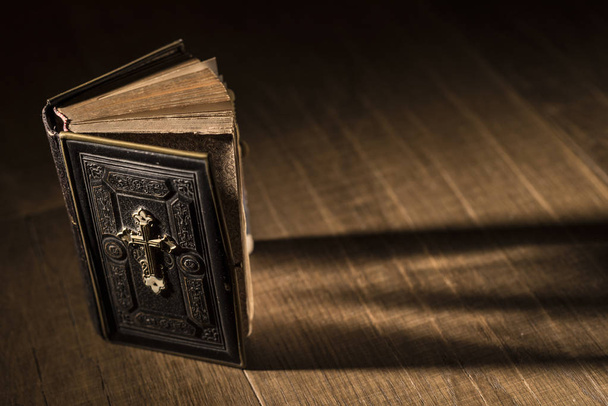 Precious antique Bible on a wooden desktop, religion and spirituality concept - Photo, Image