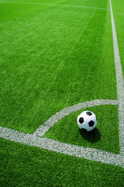 football, soccer ball, corner spot, black and white classic with lines on green artificial turf - Fotó, kép