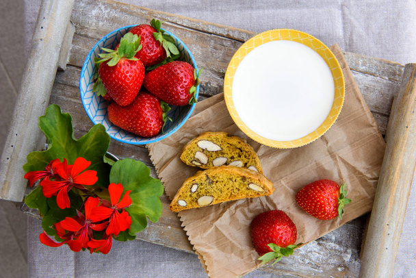  Fresh strawberries, milk, biscuits on a wooden tray. Breakfast, healthy food. Top view. - Photo, Image