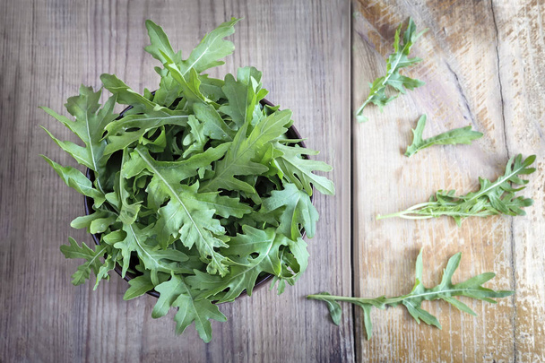 Green fresh arugula leaves on the table. Presented in close-up. - Photo, Image