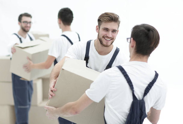 Portrait of movers holding box smiling isolated on white backgro - Fotografie, Obrázek