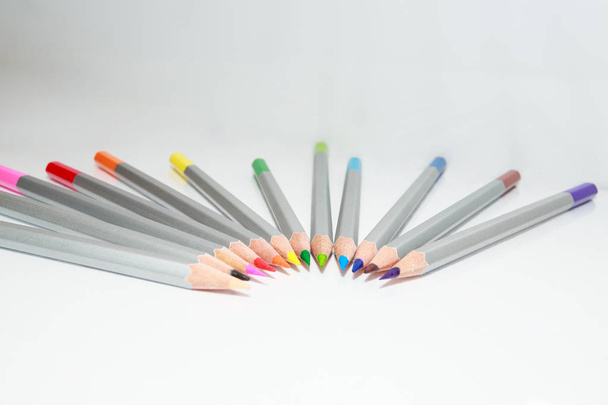 Color pencils lie in a circle on white background, copy space - Foto, imagen
