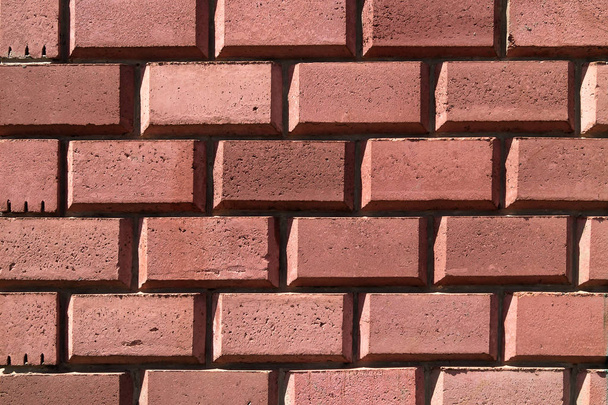 Wall of bricks in pink with deep seams, stone texture. - Photo, Image