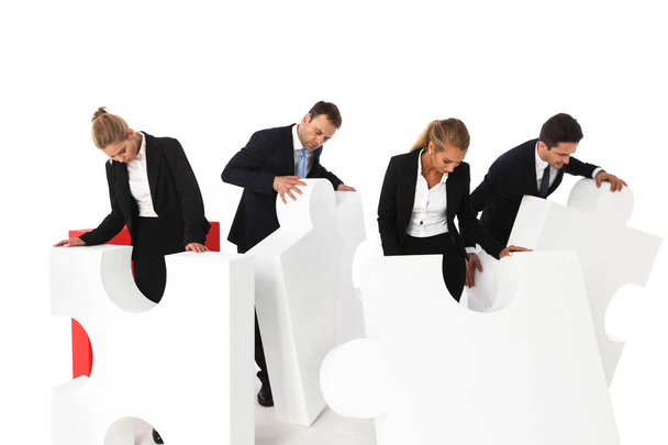 Business team assembling big puzzle isolated on white background - Photo, Image