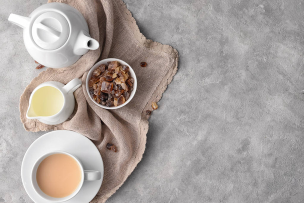 Composition with cup of tea and milk on gray background, top view - Foto, imagen