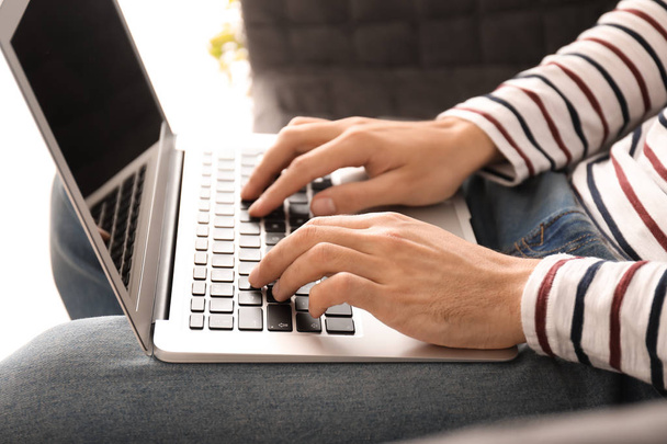 Young freelancer using laptop at home, closeup - Photo, Image