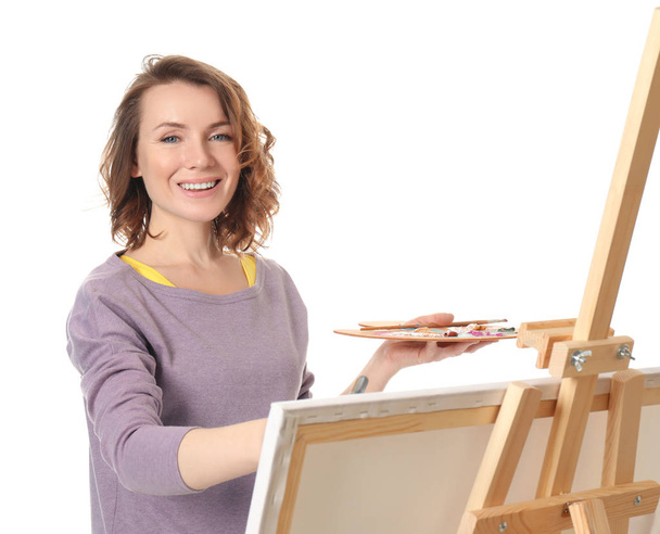 Female artist painting on white background - Photo, Image