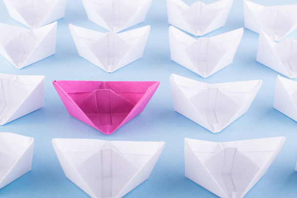 One Unique Pink Paper Boat among Many Ones. Different Paper Ships as Think Different and Creativity Concept - Photo, Image