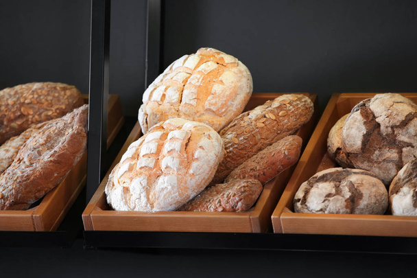 Delicious fresh bread on shelf in bakery - Photo, Image