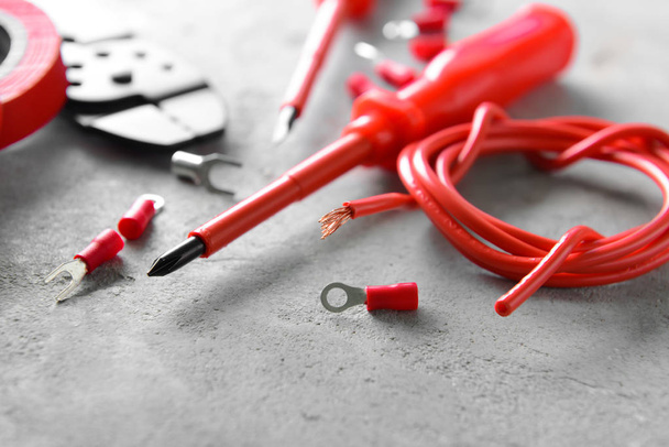 Different electrician's supplies on grey background - 写真・画像