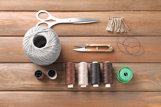 Sewing accessories on wooden background - Fotografie, Obrázek