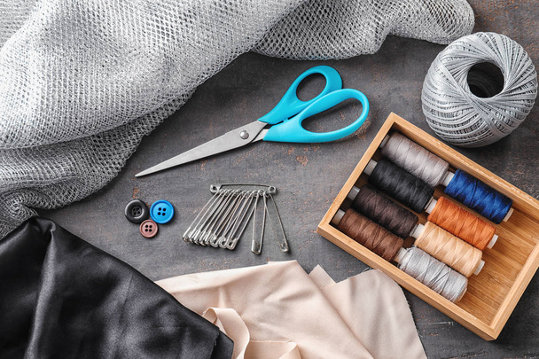 Sewing accessories on grey background - Photo, Image