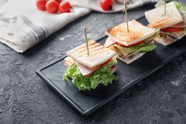 Plate with tasty sandwiches on textured table - Zdjęcie, obraz