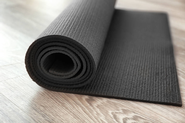 Yoga mat on wooden floor - 写真・画像