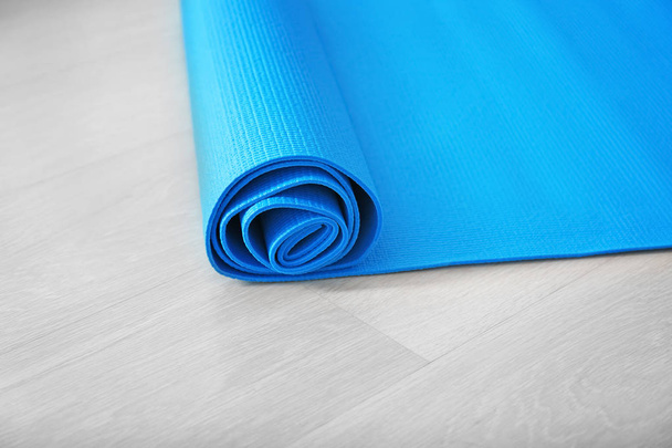 Yoga mat on wooden floor - Photo, Image