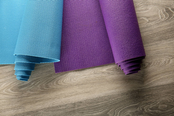 Yoga mats on wooden background - Foto, Imagem