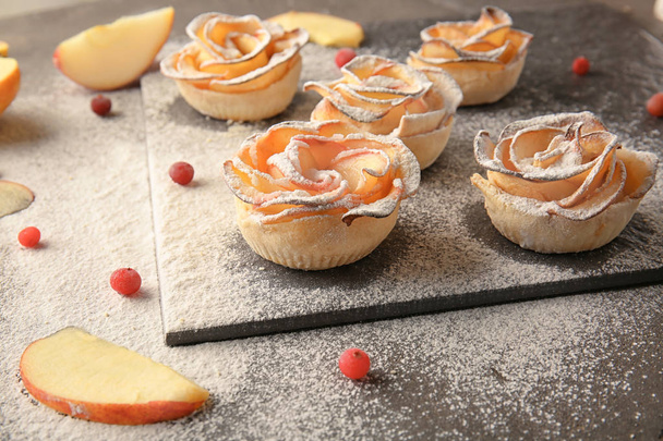 Slate board with tasty apple roses from puff pastry on table - Photo, Image