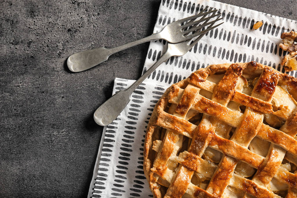 Tasty homemade apple pie on grey background - Fotó, kép