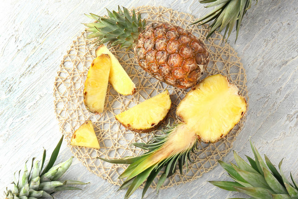 Composition with delicious pineapples on wooden background - Foto, afbeelding