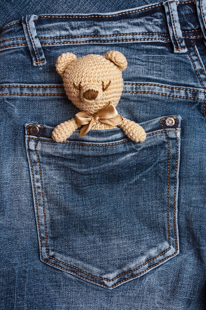 Toy bears in a jeans pocket. Vertical. Place for text. - Foto, afbeelding