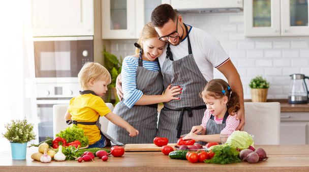 happy family with children preparing vegetable salad at hom - 写真・画像