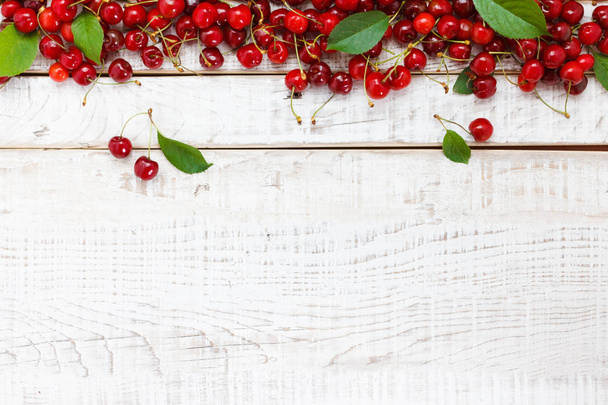 Ripe cherries on wooden table. View from above with copy space - Foto, Imagen