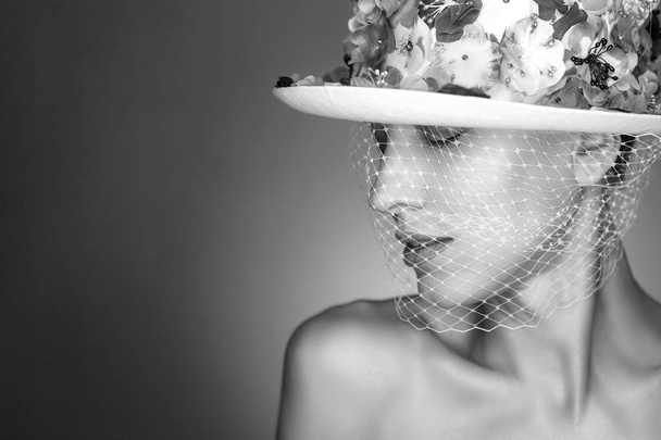 Bride. Young fashion model with perfect make-up, pink lips and bride accessories, veil on face and floral hat. Creative fashion bride, black and white image - Foto, imagen