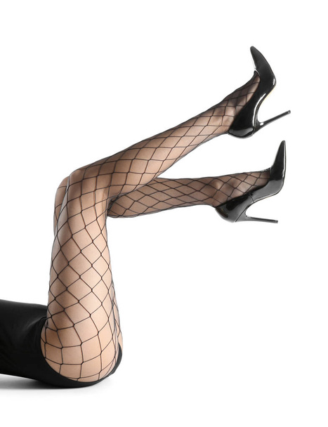 Ноги красивой молодой женщины в колготках на белом фоне
 - Фото, изображение