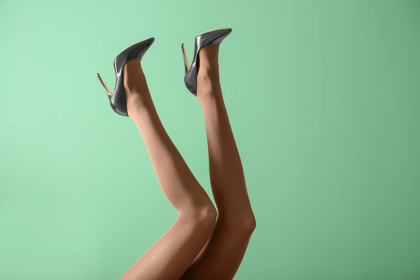 Legs of beautiful young woman in tights on color background - Φωτογραφία, εικόνα