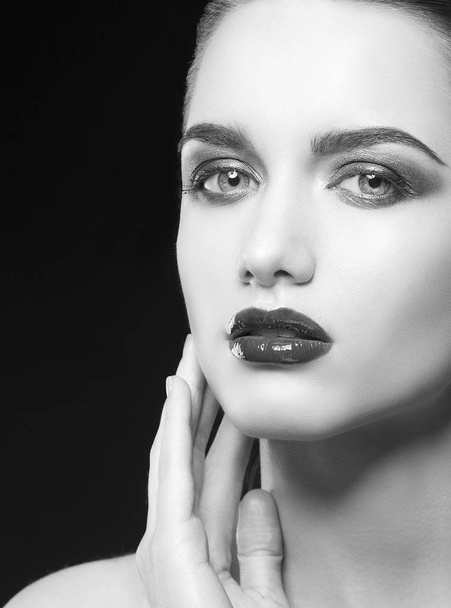 young woman with dark lips posing on black background - Фото, изображение