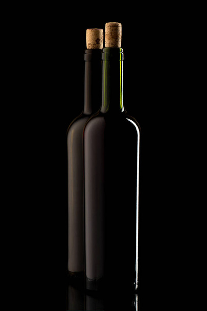 Wine bottles with cork and on black isolated background - Foto, afbeelding