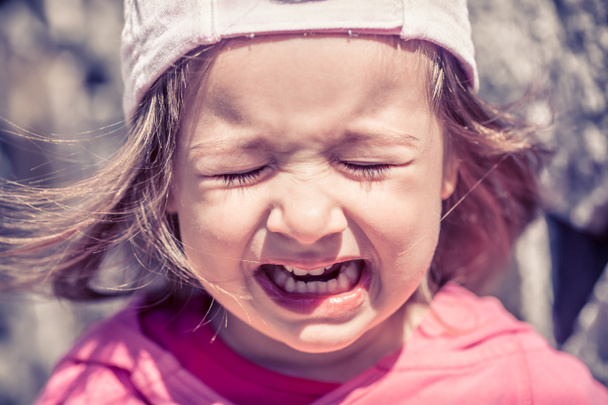 Beautiful little girl crying, tears close-up. Brightly expressed emotions of the child, the concept of a sad childhood. - Photo, Image